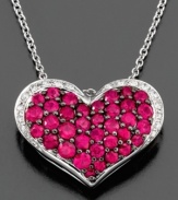 A full heart adorned with glittering, round-cut rubies (1-1/4 ct. t.w.) and diamonds (1/10 ct. t.w.) is sure to sweeten any outfit. This beautiful necklace is set in 14k white gold. Approximate length: 18 inches. Approximate drop: 1/2 inch.