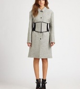 Lightweight, wool-rich coat shaped with a modified Peter Pan collar and partially exposed corset. Modified Peter Pan collarLong sleevesButton frontPartially exposed zippered corsetFully linedLonger length hits just above the knee65% virgin wool/25% nylon/10% alpacaDry cleanImportedModel shown is 5'8 (175cm) wearing US size 4.