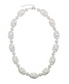 Eliot Danori's gorgeous Les Fleurs collar necklace glitters with an assortment of cubic zirconias (1-1/3 ct. t.w.) and glass crystals. Made in silver tone mixed metal. Approximate length: 16 inches + 2-inch extender.