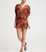 Paillettes adorn the neckline as the bold print gives this coverup a must-have status.Plunging necklineRuched and tie details on flutter sleevesPolyesterHand washImported