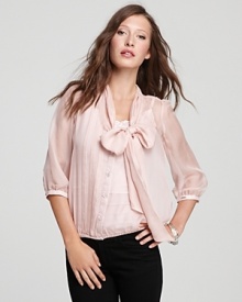 A modern take on prim and proper, this GUESS blouse touts a charming bow at the neckline for a feminine edge. A modern take on prim and proper, this GUESS blouse touts a charming bow at the neckline for a feminine edge.