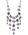 Radiant and resplendent. Betsey Johnson's bib necklace is crafted from hematite-plated silver-tone mixed metal with a starburst motif and colorful crystal accents ready to have you light up the night. Approximate length: 16 inches + 3-inch extender. Approximate drop: 4-1/2 inches.