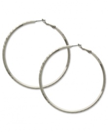 Sophisticated in silver. These classic hoop earrings from GUESS showcase subtle texture for added style. Crafted in silver tone imitation rhodium mixed metal. Approximate diameter: 2-1/2 inches. Sophisticated in silver. These classic hoop earrings from GUESS showcase subtle texture for added style. Crafted in silver tone imitation rhodium mixed metal. Approximate diameter: 2-1/2 inches.