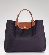 A timeless and durable nod to French style, this Longchamp nylon tote perfects daily errand-running for the très chic girl about town.