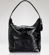 Effortless French style goes glossy with this patent leather hobo bag from Longchamp. Designed for day-to-night ease, its glamour simplified.