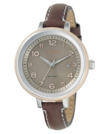 A charming and casual yet chic watch from Fossil. Featuring a brown leather strap with contrast stitch. Two-tone stainless steel round case and round brown dial with logo, date window and numeral indices. Quartz movement. Water resistant to 100 meters. 11-year limited warranty. A charming and casual yet chic watch from Fossil. Featuring a brown leather strap with contrast stitch. Two-tone stainless steel round case and round brown dial with logo, date window and numeral indices. Quartz movement. Water resistant to 100 meters. 11-year limited warranty.