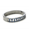 Chic and contemporary. Embellished with sparkling blue baguette crystals, Kenneth Cole New York's hinged bangle bracelet will add a sleek, modern edge to your wardrobe. Set in hematite tone mixed metal. Approximate length: 7-1/2 inches.