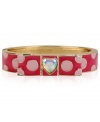 Polka dots provide a whimsical touch on this hinged bangle bracelet from Betsey Johnson. It's crafted from antique gold-tone mixed metal, and has a fuchsia bow with dots and a glass crystal accent. Item comes packaged in a signature Betsey Johnson Gift Box. Approximate diameter: 2-1/2 inches.