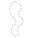 Sweep your neckline with a long, elegant strand. Monet necklace features bronze-colored resin pearls strung on a delicate gold tone mixed metal chain. Approximate length: 32 inches.