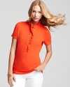 An update to the traditional polo -- pristine gold-tone buttons and feminine ruffles shake up a closet staple. Pair with jeans and Tory Burch flats for a crisp, American-girl look.