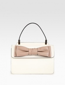 Structured leather flap silhouette adorned with a pretty front bow.Top handle, 6 dropDouble flap and snap closuresTwo inner compartmentsOne inside zip pocketTwo inside open pocketsCotton lining11¾W X 7½H X 2DMade in Italy Structured leather flap silhouette adorned with a pretty front bow.Top handle, 6 dropDouble flap and snap closuresTwo inner compartmentsOne inside zip pocketTwo inside open pocketsCotton lining11¾W X 7½H X 2DMade in Italy
