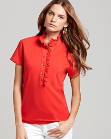 A style icon is lent a feminine perspective with a flourish of ruffles at the collar and placket of this Tory Burch polo shirt.