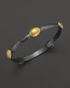 Domed 24K gold stations gleam on this hammered blackened silver bangle from Gurhan.