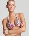 Take your enthusiasm for bold prints poolside with this triangle bikini top from ViX. In a tribal pattern, it hints at exotic chic with oversized frames and an arm full of bangles.