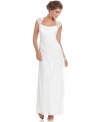 Xscape's gown features an elegant, slim silhouette and gorgeous lace cap sleeves as a finishing touch.