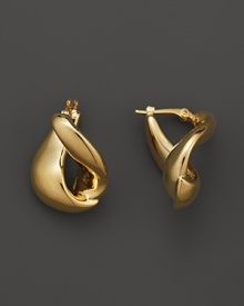 With a languid twist, a foldover hoop earring in polished 14 Kt. yellow gold. With a languid twist, a foldover hoop earring in polished 14 Kt. yellow gold.