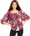 Alfani's pretty petite peasant top glows with a vibrant floral print and special details, like a pleated front placket. (Clearance)