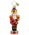 A classic nutcracker makes a grand statement upon your tree as he stands tall and proud in this hand-painted ornament from Christopher Radko.