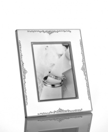 The stylized florals of Modern Love branch out on this gleaming silver-plated picture frame by Monique Lhuillier for Royal Doulton. A timeless balance of refinement and whimsy keeps memories fresh. The stylized florals of Modern Love branch out on this gleaming silver-plated picture frame by Monique Lhuillier for Royal Doulton. A timeless balance of refinement and whimsy keeps memories fresh.