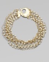 A dramatic statement, combining twisted strands of sparkling rhinestones, creamy glass pearls, faceted clear beads and golden chains into a striking piece.GlassGoldtoneLength, about 17Toggle closureImported