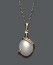 Complete the picture of ultimate elegance. A cultured freshwater pearl (12 mm x 10 mm) is cradled in a 14k gold wrap setting that shines with the addition of sparkling diamond accents. Approximate length: 18 inches. Approximate drop: 1 inch. Complete the picture of ultimate elegance. A cultured freshwater pearl (12 mm x 10 mm) is cradled in a 14k gold wrap setting that shines with the addition of sparkling diamond accents. Approximate length: 18 inches. Approximate drop: 1 inch.