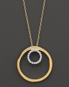 A diamond circle within a larger gold circle pendant. Designed by Meira T.