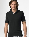 The custom fit cotton mesh polo is cut slimmer and shorter than the original. It is finished with a two-button placket, banded sleeves, uneven vented hem and an embroidered pony. Machine wash Imported