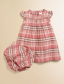 Pretty pastel checks in a crinkly, cottony fabric with feminine ruffles and ruching.Round band collarRuffled cap sleevesRuched and ruffled bodiceBack yoke, slightly gatheredFlared shapeBack buttonsMatching bloomers with elasticized waist and leg openings94% cotton/5% nylon/1% elastaneMachine washImported Please note: Number of buttons may vary depending on size ordered. Pretty pastel checks in a crinkly, cottony fabric with feminine ruffles and ruching.Round band collarRuffled cap sleevesRuched and ruffled bodiceBack yoke, slightly gatheredFlared shapeBack buttonsMatching bloomers with elasticized waist and leg openings94% cotton/5% nylon/1% elastaneMachine washImported Please note: Number of buttons may vary depending on size ordered.
