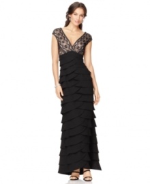 This Jessica Howard evening gown is both demure and daring, featuring an alluring lace overlay and a cascading, tiered skirt. This Jessica Howard evening gown is both demure and daring, featuring an alluring lace overlay and a cascading, tiered skirt.