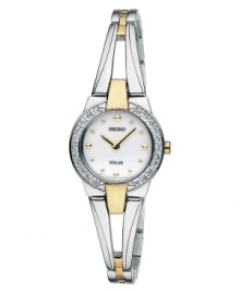 Add a new favorite to your jewelry box with this elegant and energy-efficient watch by Seiko. Polished two-tone stainless steel bangle bracelet and round case, 22mm. Bezel crystallized with Swarovski elements. White dial features gold tone dot markers, two hands and logo. Solar-powered quartz movement. Water resistant to 30 meters. Three-year limited warranty. Add a new favorite to your jewelry box with this elegant and energy-efficient watch by Seiko. Polished two-tone stainless steel bangle bracelet and round case, 22mm. Bezel crystallized with Swarovski elements. White dial features gold tone dot markers, two hands and logo. Solar-powered quartz movement. Water resistant to 30 meters. Three-year limited warranty.