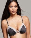 A sexy mid-coverage bra with delicate lace trim along neckline and logo embossed straps.