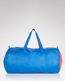 Not your basic weekender: trend-right cobalt and red accents embolden this MARC BY MARC JACOBS duffel bag that packs away for a convenient (and colorful) statement. Not your basic weekender: trend-right cobalt and red accents embolden this MARC BY MARC JACOBS duffel bag that packs away for a convenient (and colorful) statement.