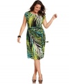 A bold botanical print beautifies Spense's cap sleeve plus size dress, featuring a faux wrap design.