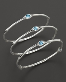 From the Batu Bamboo collection, a set of three slim bamboo bangles with blue topaz accents. Designed by John Hardy