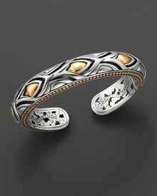 From the Naga collection, a slim kick cuff of sterling silver and 18 Kt. gold. Designed by John Hardy.