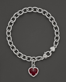 A faceted red corundum heart charm decorates a classic bracelet from Judith Ripka.