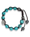 Spiritual-inspired bracelets are all the rage this season! Snap up this hot style from Ali Khan featuring semi-precious turquoise beads and pave glass fireballs on a trendy black cord. Bracelet adjusts to fit the wrist. Approximate diameter: 2 inches. Approximate length: 12-1/4 inches.