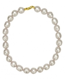 From the island of Mallorca, Spain, this necklace features white baroque organic man-made pearls (14 mm) set in 18k gold over sterling silver. Approximate length: 17 inches.