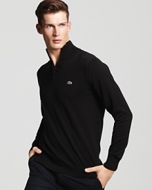 Preppy-meets-modern with a classic half-zip cotton sweater from Lacoste. Preppy-meets-modern with a classic half-zip cotton sweater from Lacoste.