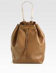 A modern and sleek design in luxurious leather with radiant hardware and a chic drawstring closure.Detachable top handle, 8 dropAdjustable shoulder straps, 3-13 dropDrawstring closureProtective metal feetOne inside zip pocketTwo inside open pocketsOne mirrorLeather lining10½W X 15H X 6½DMade in USA