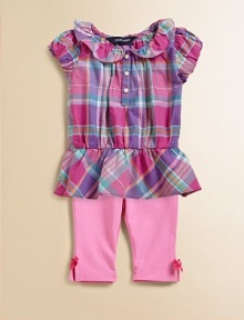 Sweet ruffles adorn a preppy madras tunic that is made complete with a matching legging for the perfect set.Ruffled Peter Pan collarShort puffed sleevesFront button placketRuffled hemElastic waistbandBow detail at hemTunic: CottonLeggings: 93% cotton/7% polyesterMachine washImported Please note: Number of buttons may vary depending on size ordered. Sweet ruffles adorn a preppy madras tunic that is made complete with a matching legging for the perfect set.Ruffled Peter Pan collarShort puffed sleevesFront button placketRuffled hemElastic waistbandBow detail at hemTunic: CottonLeggings: 93% cotton/7% polyesterMachine washImported Please note: Number of buttons may vary depending on size ordered.
