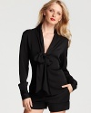 Exude office elegance in Rachel Zoe's chic v neck blouse, flaunting a bow-tie collar and rounded hem for refined femininity.