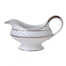 Carefully rendered in a style reminiscent of neoclassic trompe l'oeil-a French term for artwork that depicts optical illusions-a captivating geometric rosette motif traverses this elegant porcelain gravy boat from Bernardaud. Delicate shades of ice blue, mother-of-pearl and gray are enhanced by fine platinum details. Carefully rendered in a style reminiscent of neoclassic trompe l'oeil-a French term for artwork that depicts optical illusions-a captivating geometric rosette motif traverses this elegant porcelain gravy boat from Bernardaud. Delicate shades of ice blue, mother-of-pearl and gray are enhanced by fine platinum details.