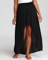 Simple goes sleek as this Bloomingdale's Exclusive JET by John Eshaya maxi skirt is made dramatic with a deep black hue and on-trend high/low hem.