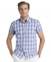 Trim up. Get a sleeker look without doing a thing in this slim-fit plaid shirt from Izod.