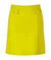 Defy the workweek style rut with this bold yellow A-line skirt from Tara Jarmon - A-line silhouette, front flap pockets with buttons, front and back seaming detail, concealed side zip closure - Wear with a printed silk top, a blazer, and ballet flats