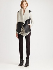 An oversized layering piece crafted of textured leather lined with ultra-soft shearling. Asymmetrical neckline with shearling trimSleevelessFront clasp closureFront slash pocketsAbout 30½ from shoulder to hemBody: LambskinLining: Genuine lamb shearlingDry clean with fur specialistImported of Italian fabricFur origin: ChinaModel shown is 5'10 (177cm) wearing US size Small. An oversized layering piece crafted of textured leather lined with ultra-soft shearling. Asymmetrical neckline with shearling trimSleevelessFront clasp closureFront slash pocketsAbout 30½ from shoulder to hemBody: LambskinLining: Genuine lamb shearlingDry clean with fur specialistImported of Italian fabricFur origin: ChinaModel shown is 5'10 (177cm) wearing US size Small.