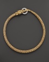 An 18K yellow gold dragon clasps a diamond pavé link in this striking necklace from John Hardy.