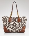 MICHAEL Michael Kors puts a safari-inspired spin on the classic tote with leather trims and statement stripes. Carry this bold bag to lend daytime basics exotic flair.