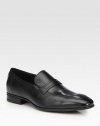 Sophisticated slip-on style crafted in smooth, supple leather and accented with an apron-toe finish.Leather upperLeather liningPadded insoleRubber soleImported